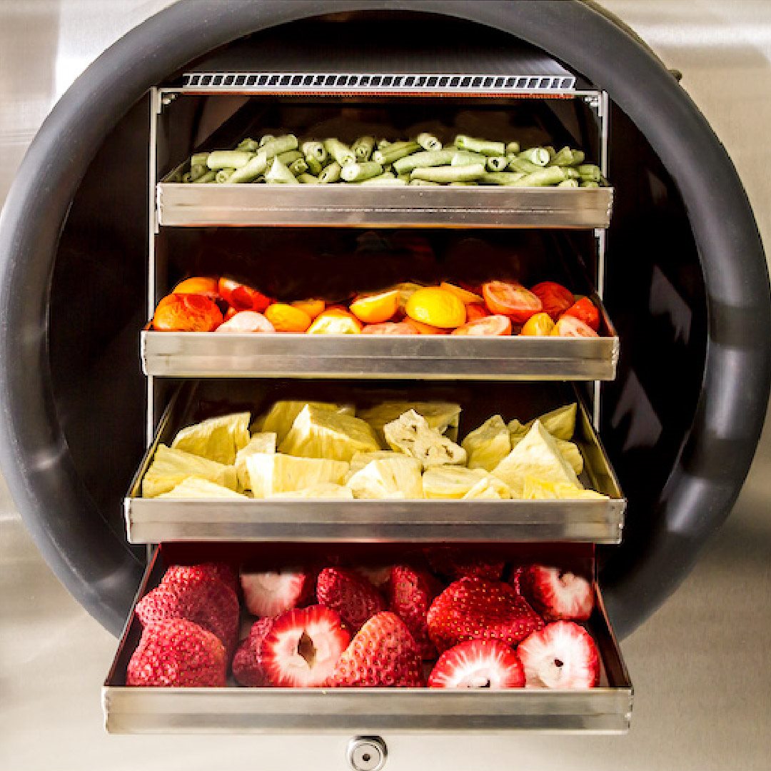 A Home Pro freeze dryer beside packaged food storage