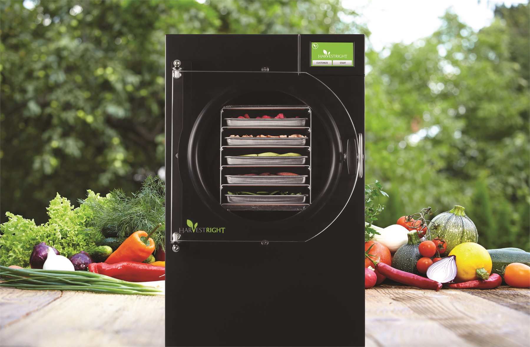 Home Pro freeze dryer with trays of colourful food